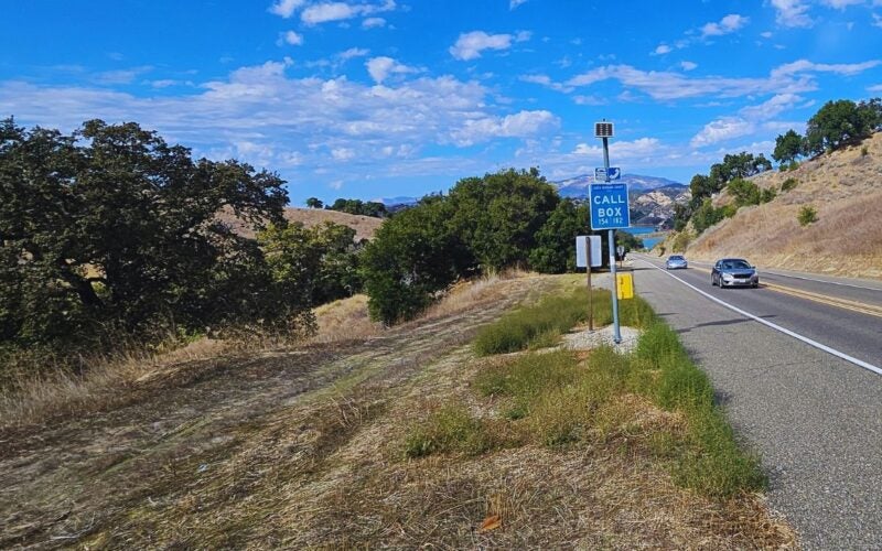 Depicts call box with lack cachuma in background